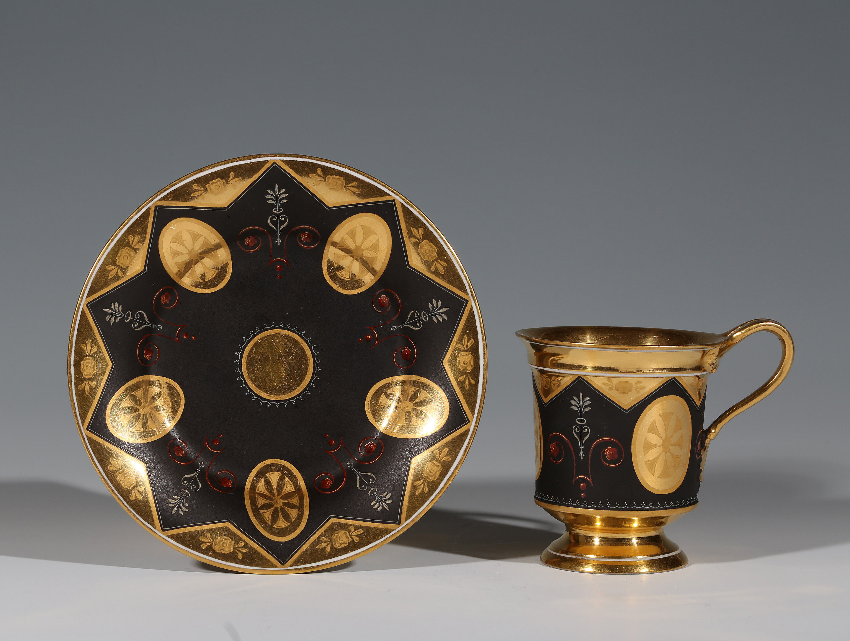 A Vienna Gold and black ground cup and saucer